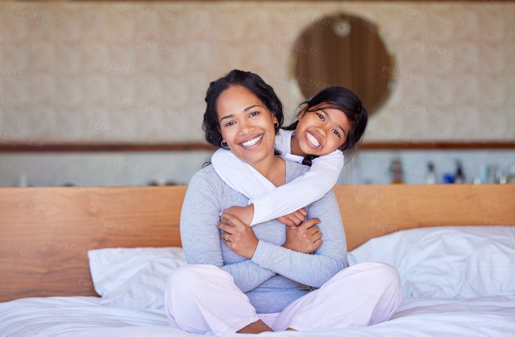 Buy stock photo Bedroom, Indonesian mother and child in portrait for bonding with family, smile or hug in house. Mom, daughter or happiness in home or embrace for wellness, learning and development or parenting