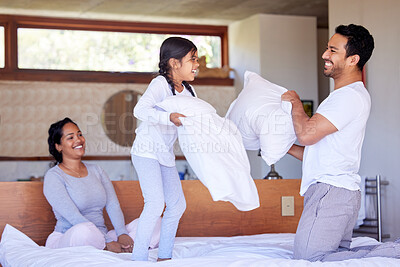 Buy stock photo Morning, family and pillow fight game with mom, dad and child together on bed with fun and bonding. Playing, smile and comedy in home with girl, love and care in a bedroom with funny youth and joy