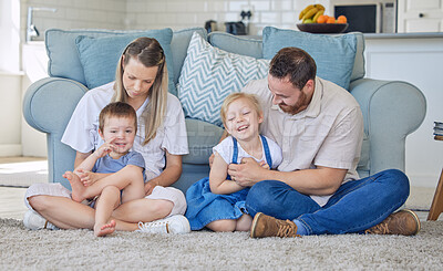 Buy stock photo Parents, living room and happy together in home, bonding and love with family playing in apartment lounge. Weekend, break and childhood with people, sofa and children on floor or relax in house