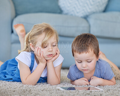 Buy stock photo Children, floor and tablet in house for online, video and streaming cartoon as siblings in living room. Girl, boy and technology in home for superhero movie on website, app and internet on carpet