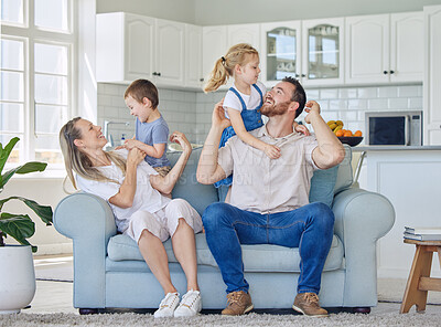 Buy stock photo Fun, smile and family relax on sofa house for bonding, love and care or hug in living room together. Happy, woman and man with children for childhood, support and trust of memory at home break