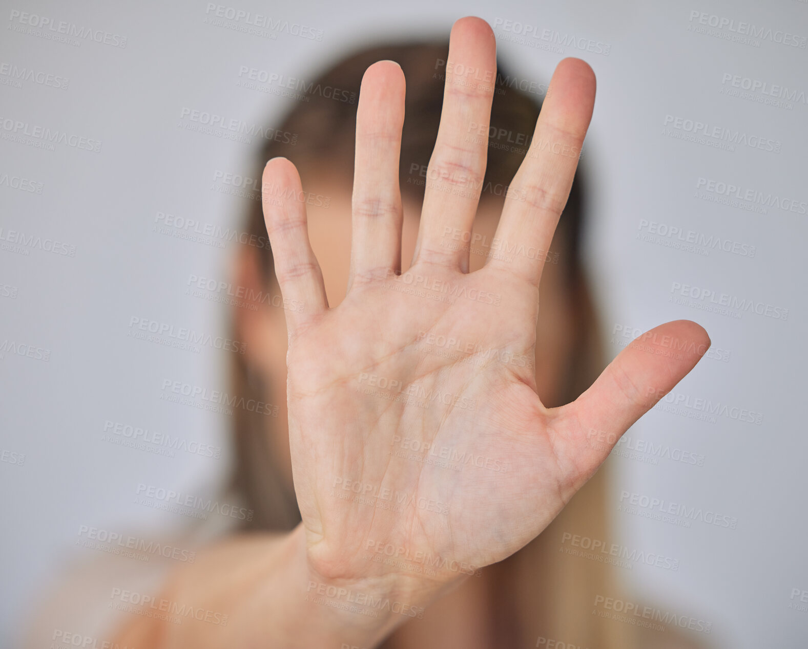 Buy stock photo Abuse, hand and stop with victim person in studio on gray background for awareness or conflict. Domestic violence, palm and sexual harassment with gesture of woman for protection or self defense