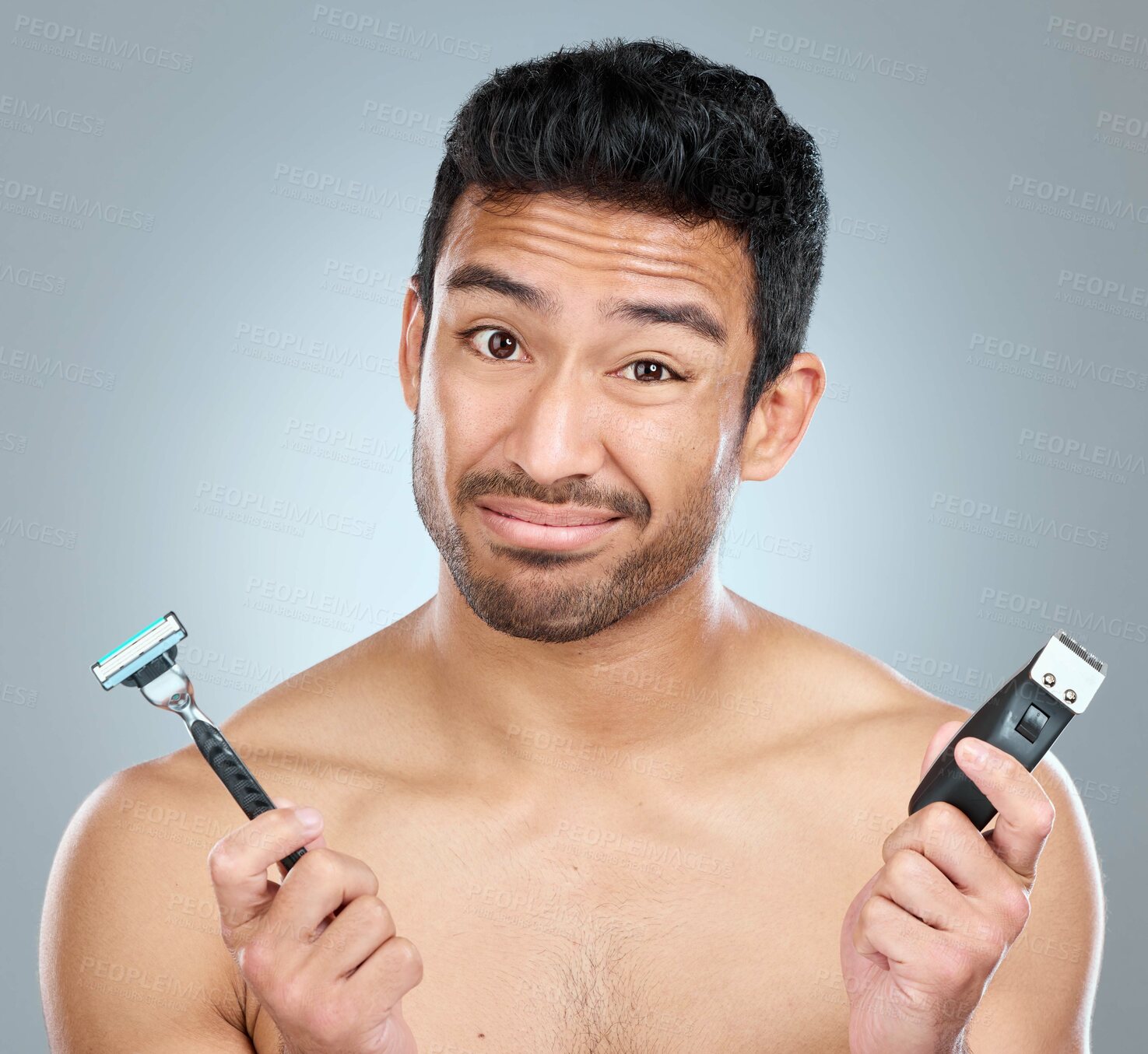 Buy stock photo Model, razor and choice for skincare, grooming or facial treatment on a gray studio background. Hygiene, decision and man for portrait, trimming and confused for morning beard routine with doubt