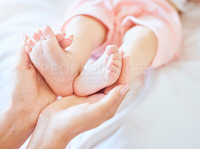 Buy stock photo Parents, bed and hands with feet of baby for affection, bonding and loving relationship in home. Family, motherhood and mom holding infant toes in bedroom for love, child development and care