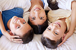 Portrait of a mixed race family in bed together. Mother with her adoptive sons. Young mother relaxing with her children. Mixed race family relaxing together with her boys spending time together 