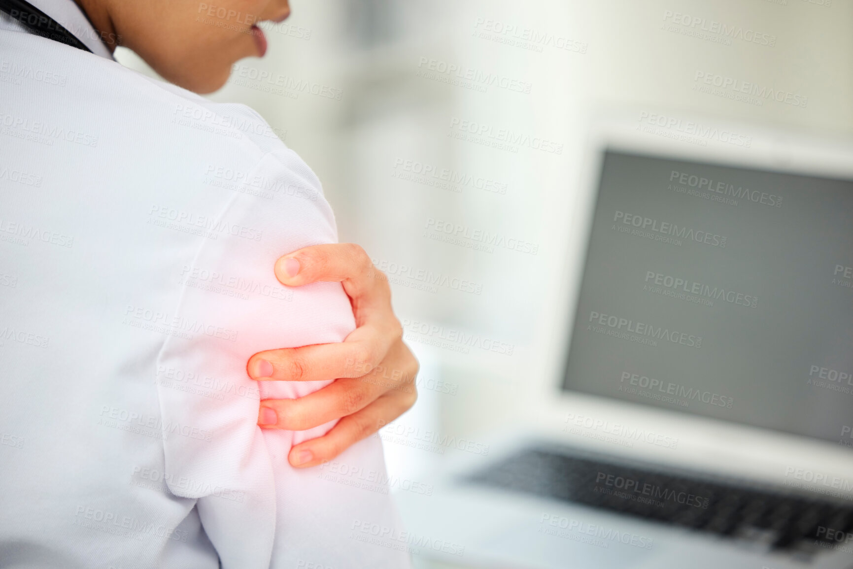 Buy stock photo Hospital, office and doctor with shoulder pain at desk for emergency, tension and work injury. Healthcare, professional and person with red glow by laptop for medical problem, inflammation and strain