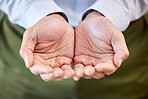 Close up of a businessman in formal clothing holding something imaginary on palms of his hands. Unknown man making a begging gesture with his hands