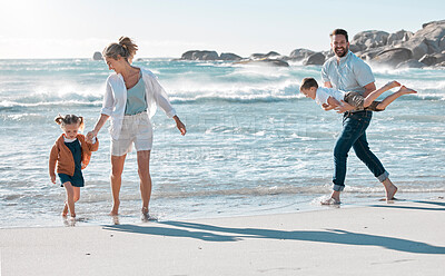 Buy stock photo Parents, children and playing on beach for holiday with bonding, fun walk and summer vacation. Happy family, couple and kids in water at ocean for getaway trip, travel and scenery with love and care