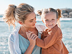 Loving caucasian mother at the beach with her adorable little daughter. Mom and child enjoying beach day during summer vacation. Single mother enjoying quality time with her daughter