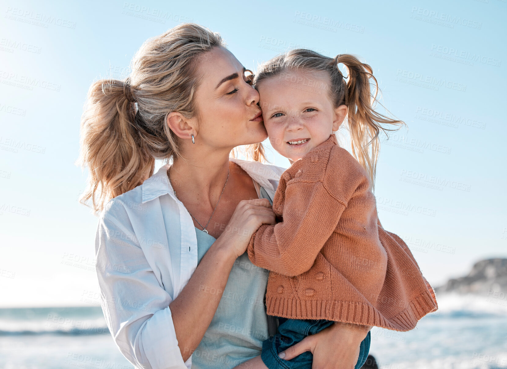Buy stock photo Beach, happy and mom with child kiss for holiday, vacation and adventure in nature. Family, travel and portrait of mother carrying girl by ocean for bonding, relationship and fun by seaside to relax