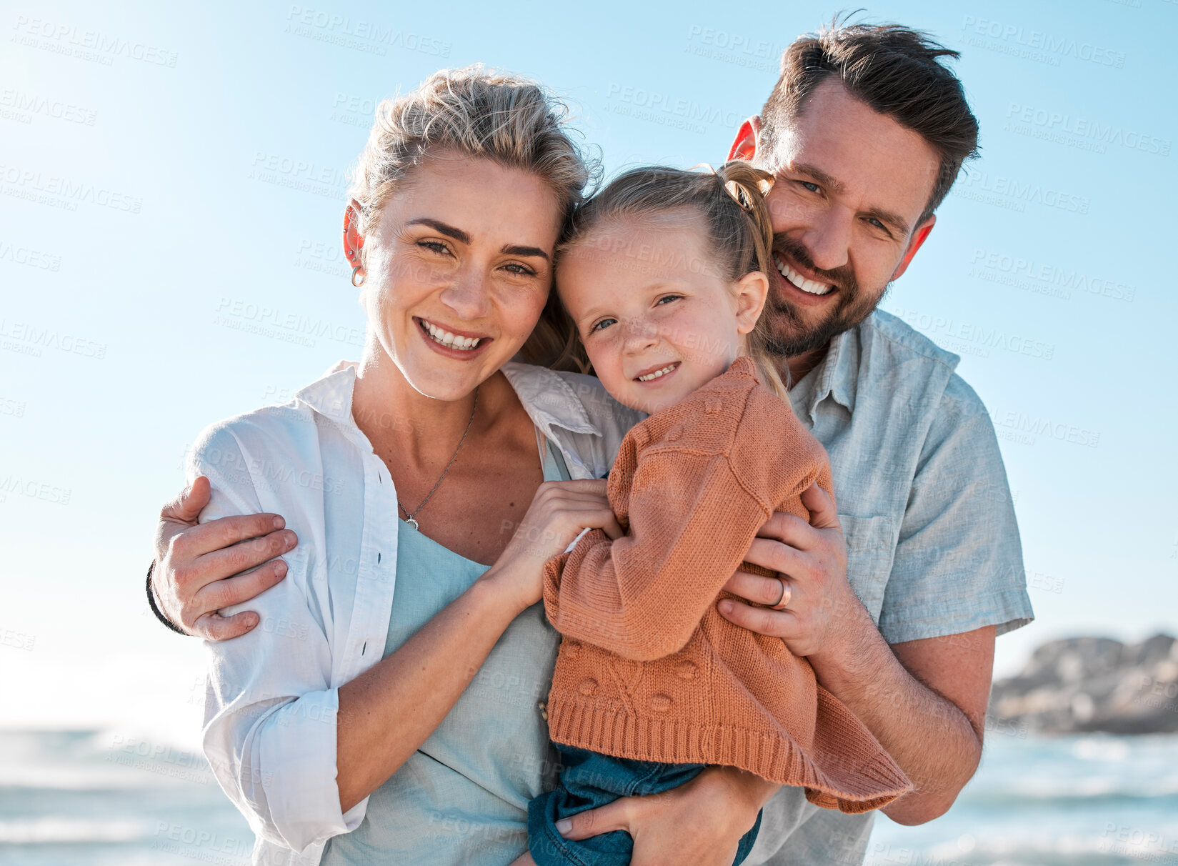 Buy stock photo Beach, happy and portrait of parents with child for holiday, vacation and adventure in nature. Family, travel and mom, dad and girl by ocean for bonding, relationship and fun by seaside to relax