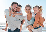 Happy parents carrying their little children during a day on the beach. Smiling boy and girl enjoying free time with their mother and father. Smiling couple bonding with their children on a weekend