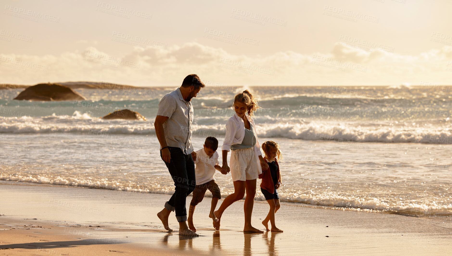 Buy stock photo Parents, children and holding hands for sunset by ocean with waves, outdoor and connection on holiday. People, family and kids with care, love and bonding in nature for vacation at beach in Italy