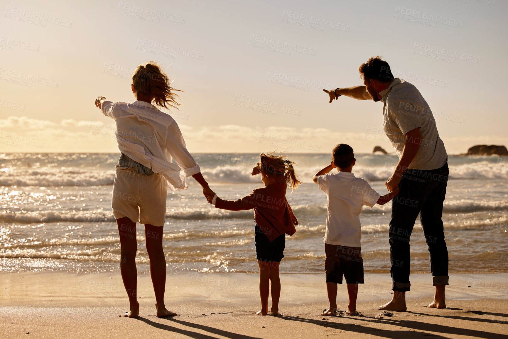 Buy stock photo Sunset, parents and children holding hands on beach for holiday adventure together in tropical island waves. Mother, father and kids on ocean vacation with travel, relax and family bonding from back