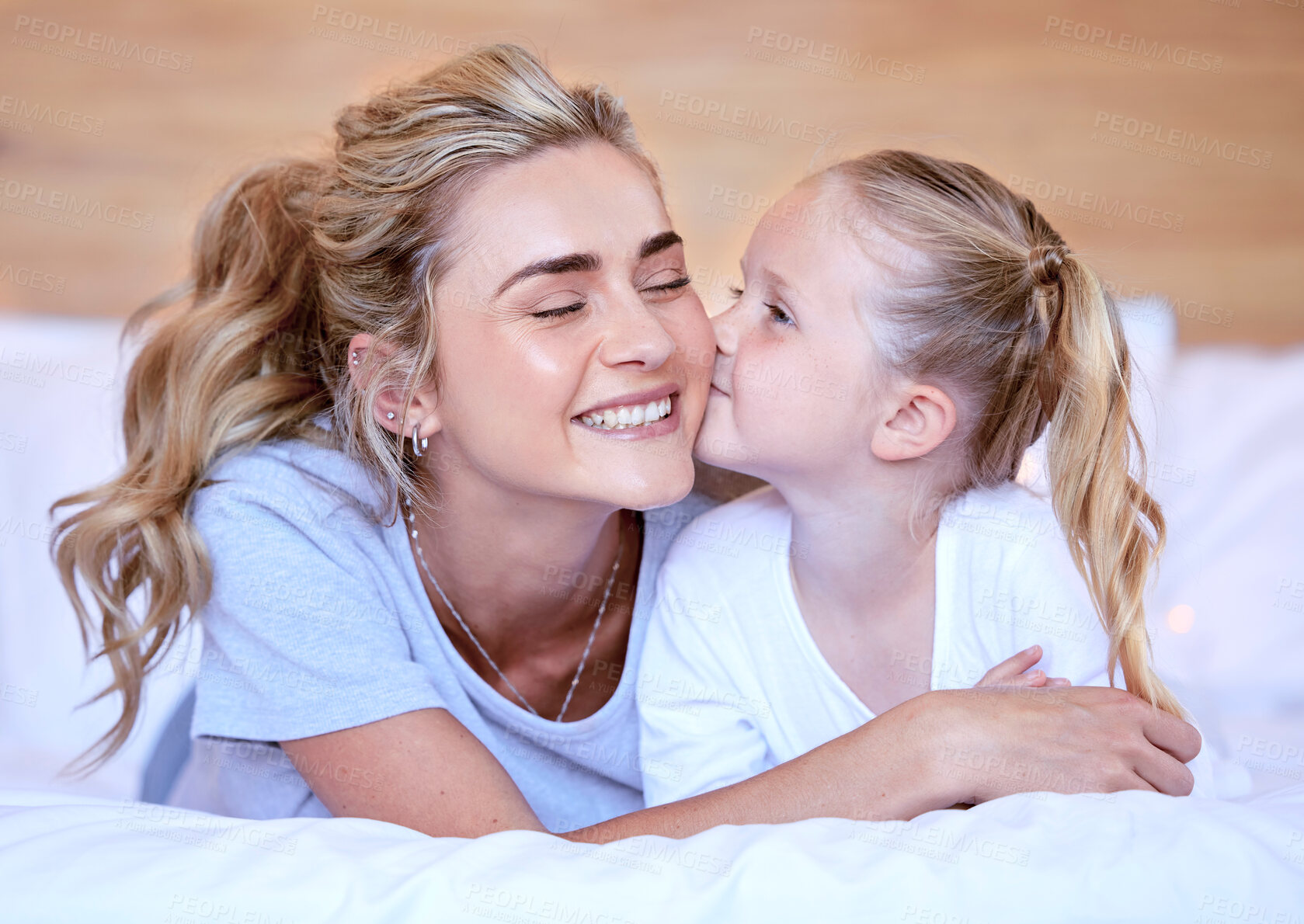 Buy stock photo Kiss, mom and girl in bed for smile, rest and bonding in bedroom of family home. Happy, parent and mother person with affection and young child for unity, support and love or cozy together on weekend