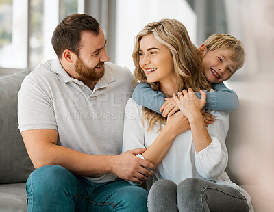 Buy stock photo Playing, hug and child with property, happy family or house to relax with security, safety and care. Smile, love or proud parents on couch with boy, support and trust for bonding together in home