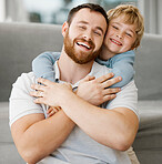 Cute little smiling caucasian boy hugging dad from behind at home. Carefree happy dad receiving love and affection from playful son. Man feeling special while enjoying special moments on father's day