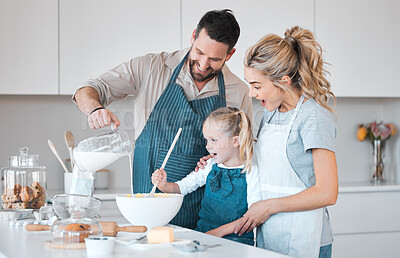 Buy stock photo Kitchen baking, family and learning kid cooking, happy and help prepare milk, flour or food ingredients. Parents, love and fun or mother bonding with father, daughter development, support and care