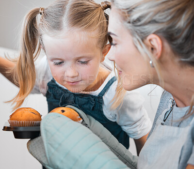 Buy stock photo Kitchen baking, mother and happy girl smelling, smile and excited for muffins, cupcakes or sweet food. Mama, love and family fun or woman bonding with daughter, child development support and home