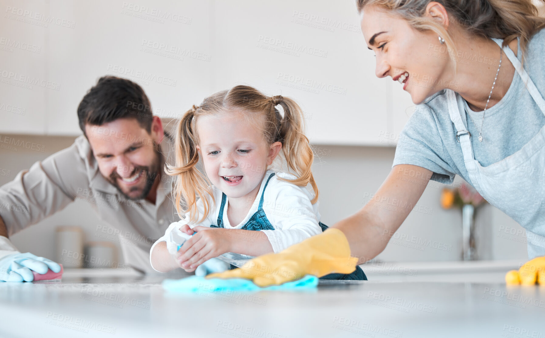 Buy stock photo Family, parents and child with kitchen counter for cleaning, bacteria and disinfect spray for hygiene. Home, mother and father with girl for help, learn and bottle with motor skills for development