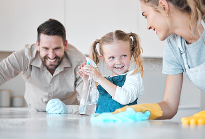 Buy stock photo Family, parents and kid with kitchen counter for cleaning, bacteria and disinfect spray for hygiene. Home, mom and dad with girl for help, learn and bottle with motor skills for child development