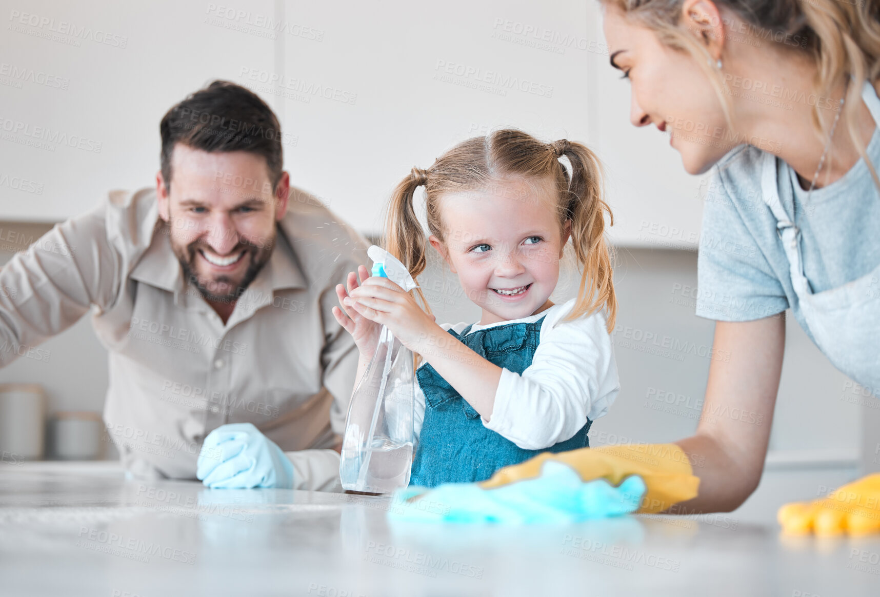 Buy stock photo Family, parents and kid with kitchen counter for cleaning, bacteria and disinfect spray for hygiene. Home, mom and dad with girl for help, learn and bottle with motor skills for child development