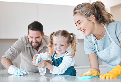 Buy stock photo Family, parents and girl with kitchen counter for cleaning, bacteria and disinfect spray for hygiene. Home, mother and father with child for help, learn and bottle with motor skills for development