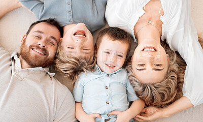 Buy stock photo Above, portrait and happy family on floor for love, support and relax together in home. Mom, dad and parents with kids or excited for new house, wellness and protection or care in lounge or apartment