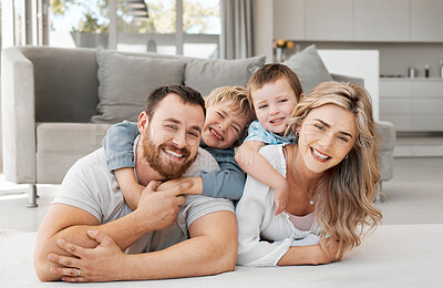 Buy stock photo Happy, portrait and family or hug on floor for love, support and relax in lounge or home. Mom, dad and together with kids and excited for new house, wellness and security for care in living room