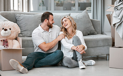 Buy stock photo Couple, laughing and smile with boxes, clothes and teddy bear for moving, celebration and new home. People, cardboard and happiness for real estate, apartment and property with investment on floor