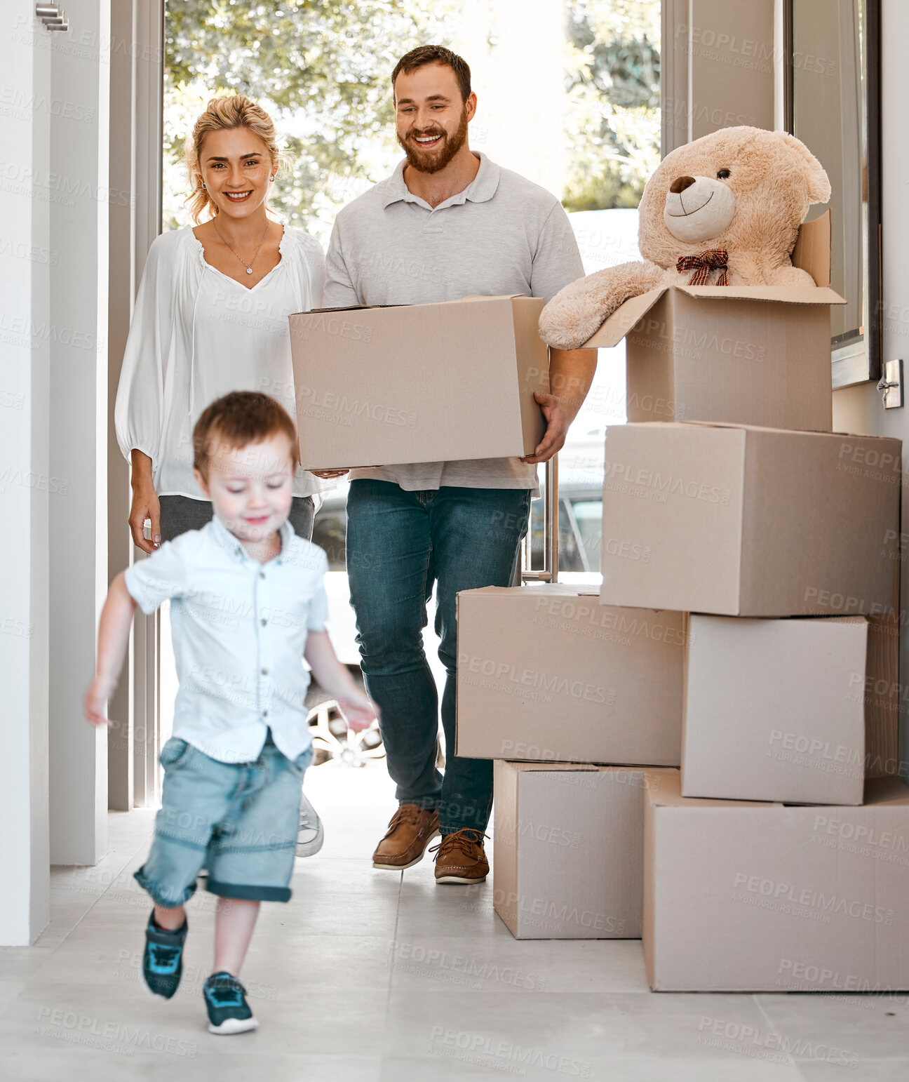 Buy stock photo New home, family and dad with box for move, property investment and mortgage loan approval for sale. Real estate, parents and excited boy in passage for fun, happiness and bond agreement for security