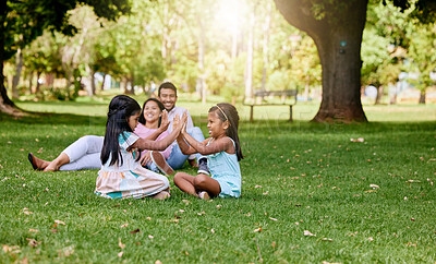 Buy stock photo Family, playing and children in nature park, siblings and traditional or hand games on grass on summer break. Parents, relaxing and girls for child development, bonding and fun activity with people