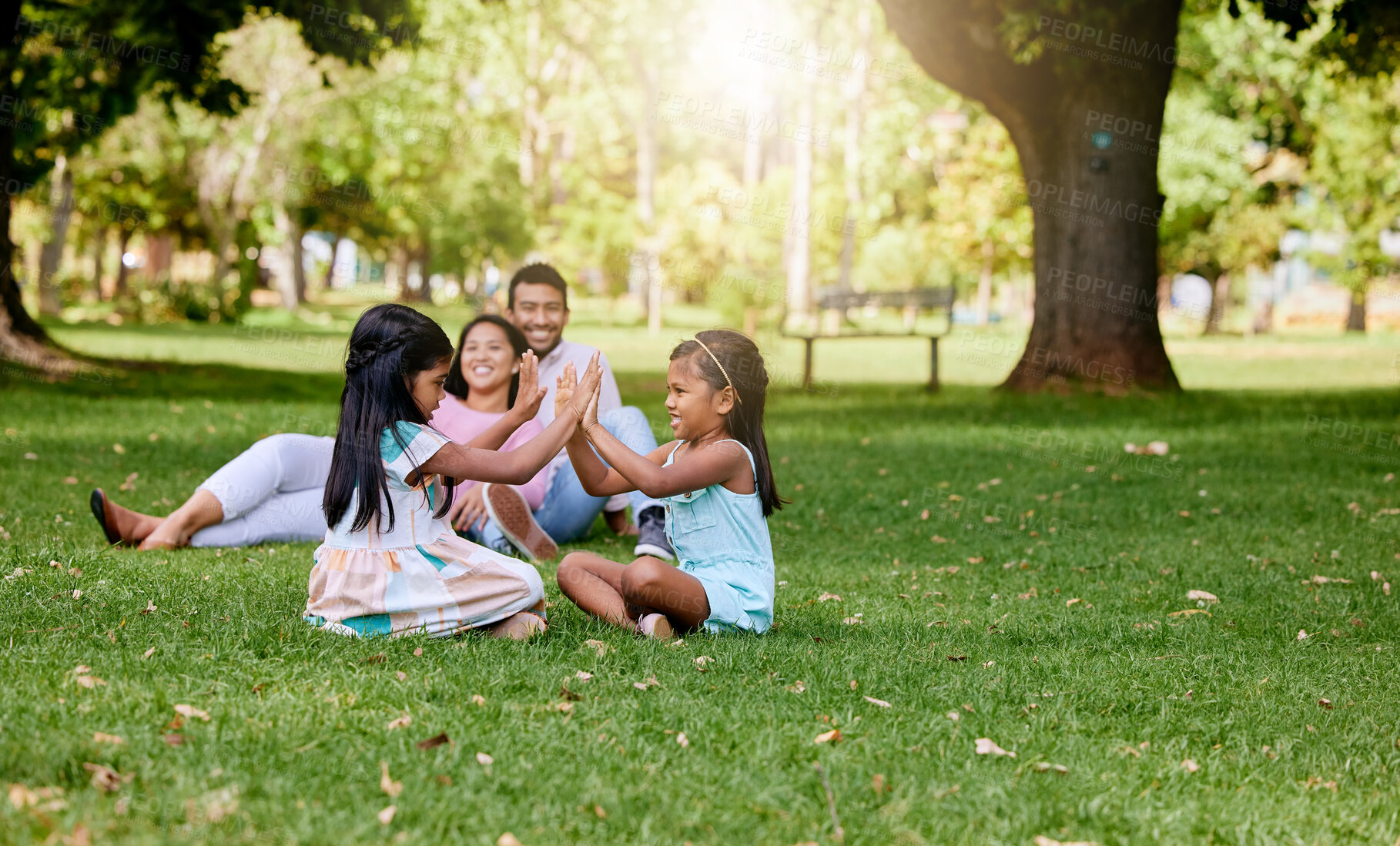 Buy stock photo Family, playing and children in nature park, siblings and traditional or hand games on grass on summer break. Parents, relaxing and girls for child development, bonding and fun activity with people