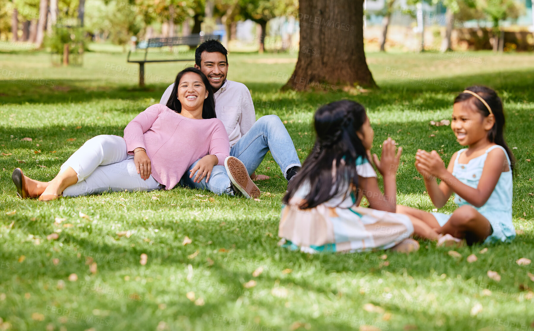 Buy stock photo Family, playing and kids in nature park, siblings and traditional or hand games on grass on summer break. Parents, relaxing and girls for child development, bonding and fun activity with people