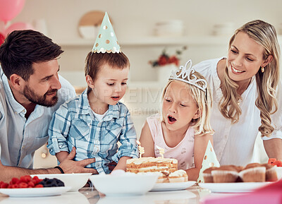 Buy stock photo Family, birthday party and candles in home for blowing or wish, siblings and happiness for celebration with cake. Mother, father and children in house for bonding on special day, together and excited