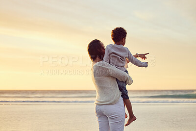 Buy stock photo Mom, child and pointing at beach for love, care and vacation during summer with sunset, happiness and hug. Mother, boy and relax outdoor for nature, freedom and holiday with travel, bonding or fun