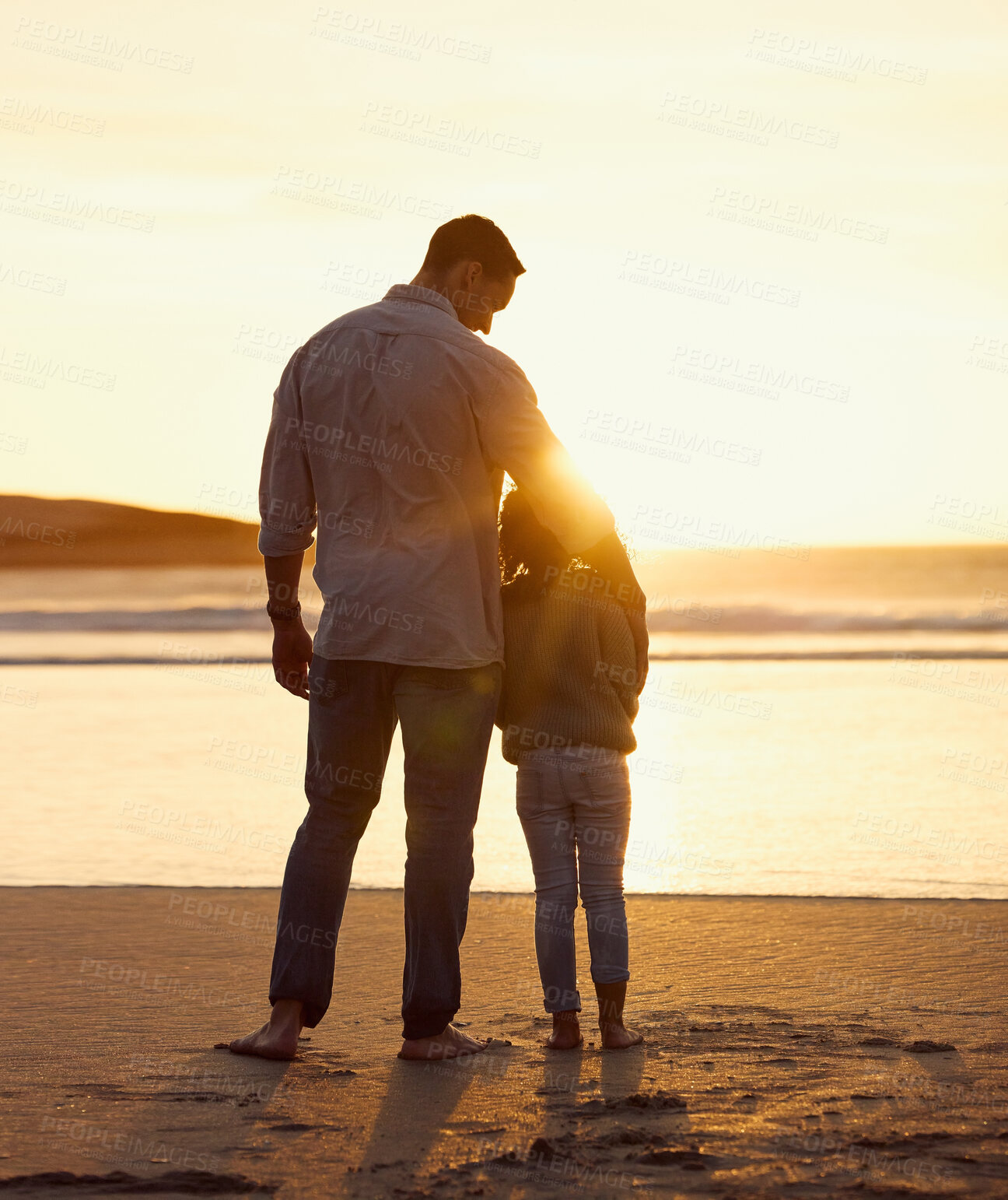 Buy stock photo Dad, kid and hug at beach for sunset, care and vacation during summer with sun, view and water. Father, child and relationship outdoor for love, childhood and holiday with travel, bonding and embrace