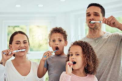 Buy stock photo Family portrait, parents and kids in bathroom for brushing teeth, healthcare and bonding to start morning in house. Father, mother and children with toothbrush, smile and health for medical self care