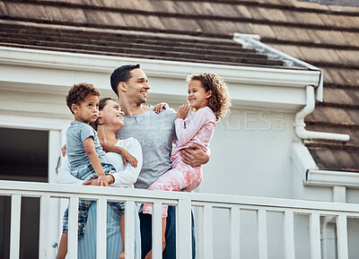 Buy stock photo Happy, family and outdoor on balcony with love, affection and bonding with hug for care or connection. Mother, father and children by modern house with pajamas in morning, together and support.