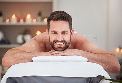 Buy stock photo Relax, portrait and man at spa for massage, therapy and  wellness on table for luxury holistic treatment. Self care, smile and client on bed for body health, muscle care and peace with hotel service