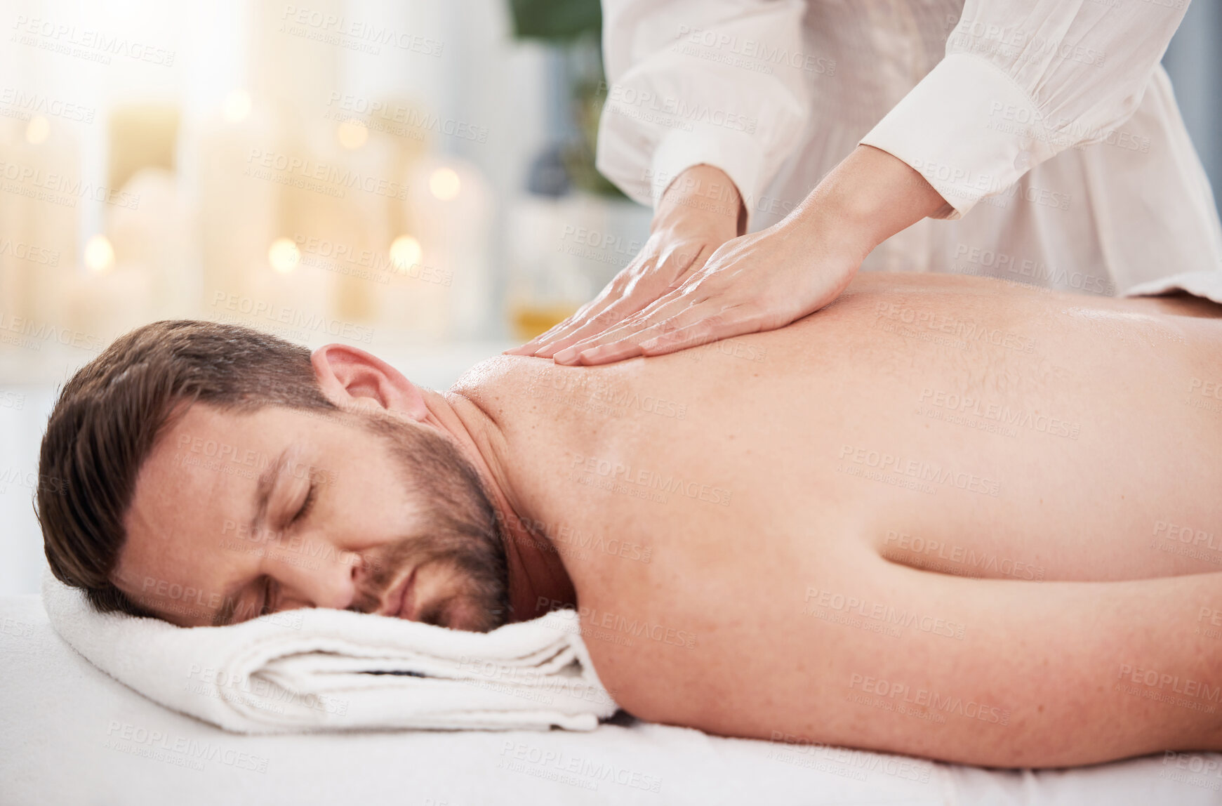 Buy stock photo Relax, spa and man with back massage, wellness therapy and luxury holistic treatment on table. Self care, masseuse and sleeping client on bed for body health, muscle and peace with hotel service