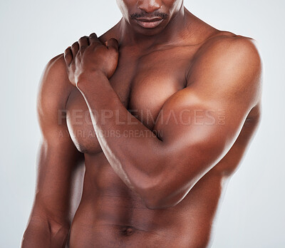 Buy stock photo Black man, topless and body with shoulder pain in studio for fitness, bodybuilding and sports injury. Muscular, male person and arm with problem for strain, tension and accident on white background