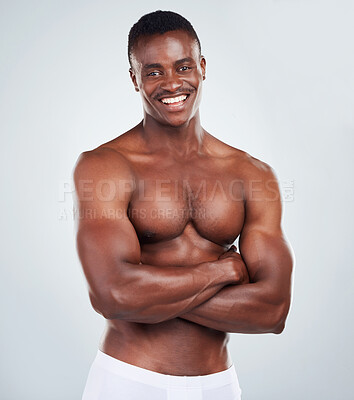 Buy stock photo Muscular, black man and portrait in studio with fitness for muscle growth, strong body or power. Athlete, happy and topless with biceps strength, underwear or wellness on gray background mockup space