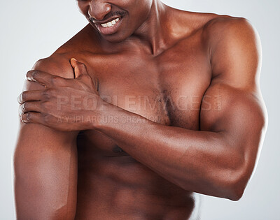 Buy stock photo Black man, shirtless and hurt with shoulder pain in studio for bodybuilding, injury and accident. Muscular, male person and arm with problem for fitness, training and inflammation on white background