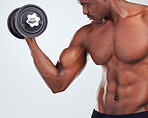 One young African American fitness model posing topless while exercising with dumbbells .Confident black male athlete isolated on grey copyspace while weightlifting in a studio