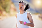 Active mixed race young woman running for exercise outdoors. Athlete jogging for a refreshing cardio training workout in the morning. Determined to build endurance to reach fitness and wellness goals