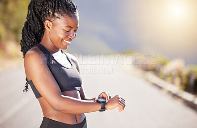 Buy stock photo Happy black woman, runner and checking with watch for fitness, performance or tracking on mountain road. Young African, female person or athlete with smile for wristwatch, workout or outdoor exercise