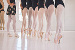 Closeup woman dance instructor teaching a ballet class to a group of a children in her studio. Ballerina teacher working with girl students, preparing for their recital, performance or upcoming show