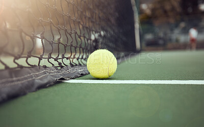 Buy stock photo Tennis, court and outdoors with ball by net for sports match, tournament and practice at sunset. Green, sphere and stadium with fiber texture of equipment for game, activity and competition in Paris