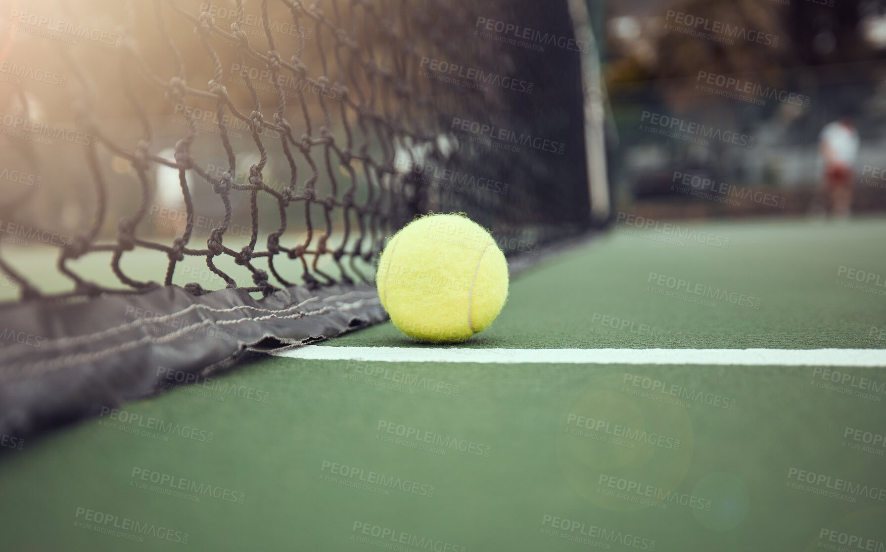 Buy stock photo Tennis, court and outdoors with ball by net for sports match, tournament and practice at sunset. Green, sphere and stadium with fiber texture of equipment for game, activity and competition in Paris